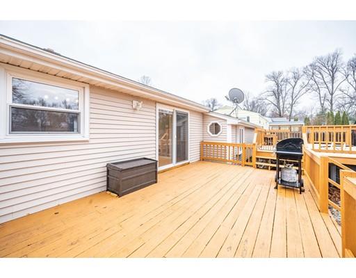 44 Corey Road Springfield, MA 01128 - Photo 24 of 29 a view of a patio with dining table and chairs with wooden floor
