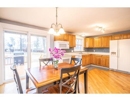 44 Corey Road Springfield, MA 01128 - Photo 9 of 29 a view of a dining room and livingroom with furniture wooden floor a chandelier
