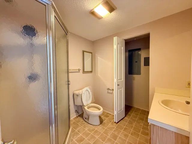 a bathroom with a toilet sink and shower