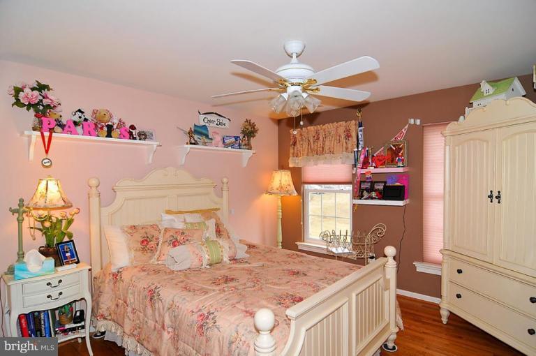 10019 German Road Ellicott City, MD 21042 - Photo 20 of 30 a bedroom with a bed a window and a chandelier