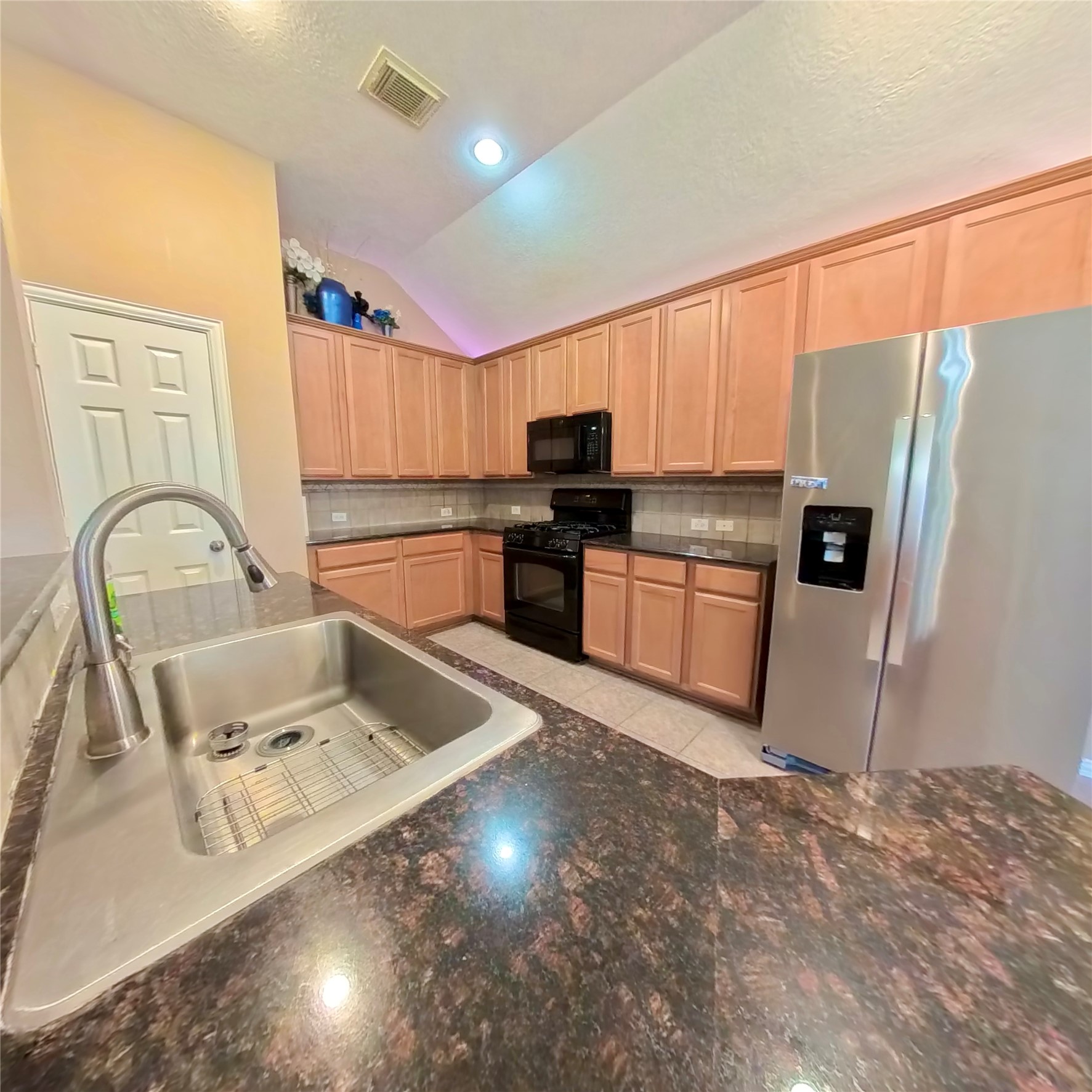 30938 Blue Ridge Park Lane Spring, TX 77386 - Photo 24 of 32 a kitchen with stainless steel appliances granite countertop a sink refrigerator and microwave