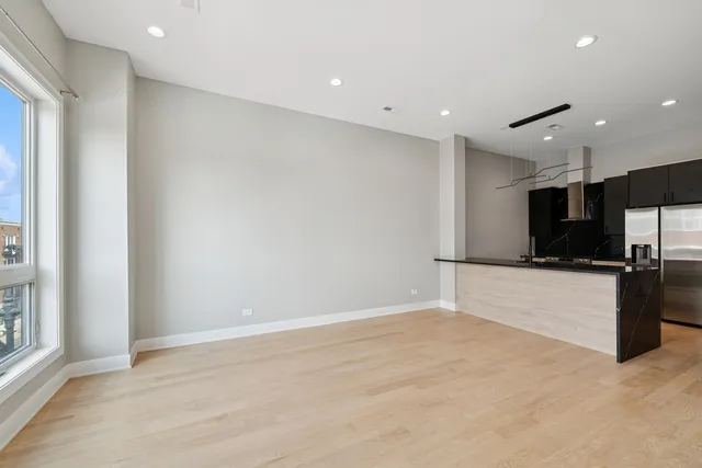 a view of kitchen with refrigerator and microwave