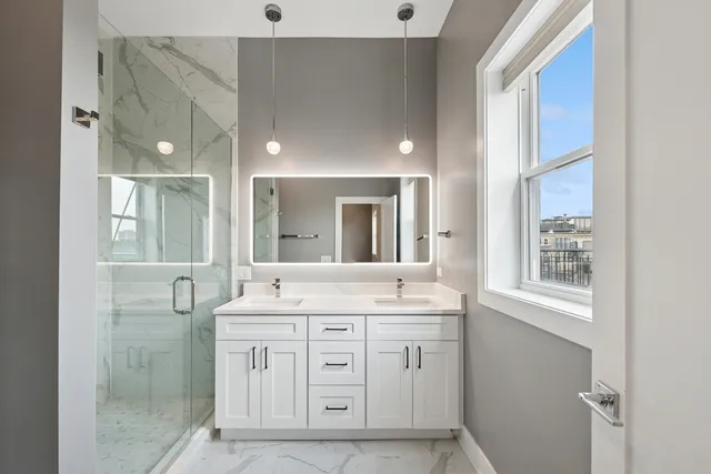 a spacious bathroom with a shower a sink and a mirror