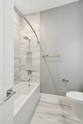 a bathroom with a bathtub and shower