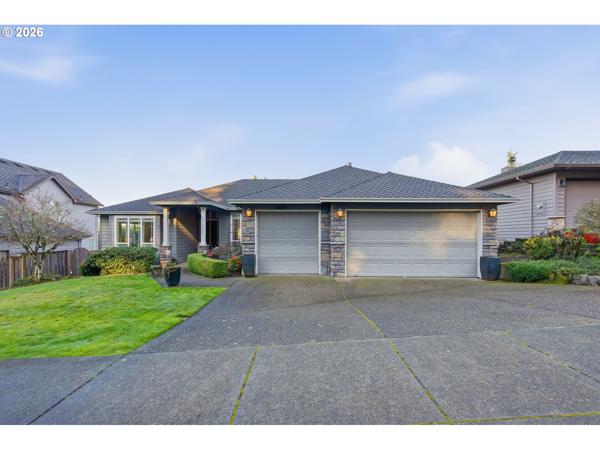 11086 Southeast Rimrock Drive Happy Valley, OR 97086 - Photo 1 of 39 a front view of a house with a yard and garage