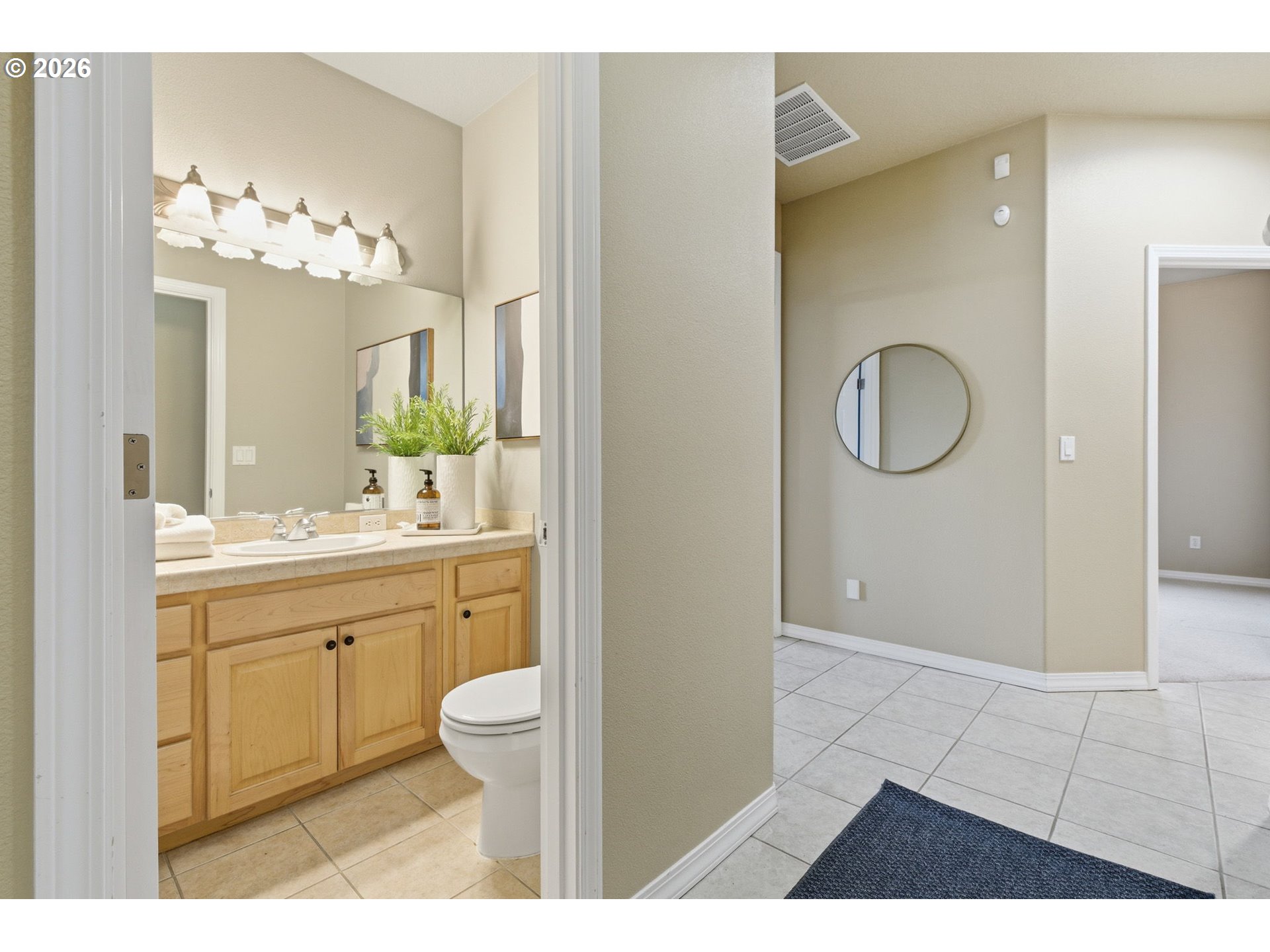 11086 Southeast Rimrock Drive Happy Valley, OR 97086 - Photo 16 of 39 a bathroom with a sink a toilet and a mirror