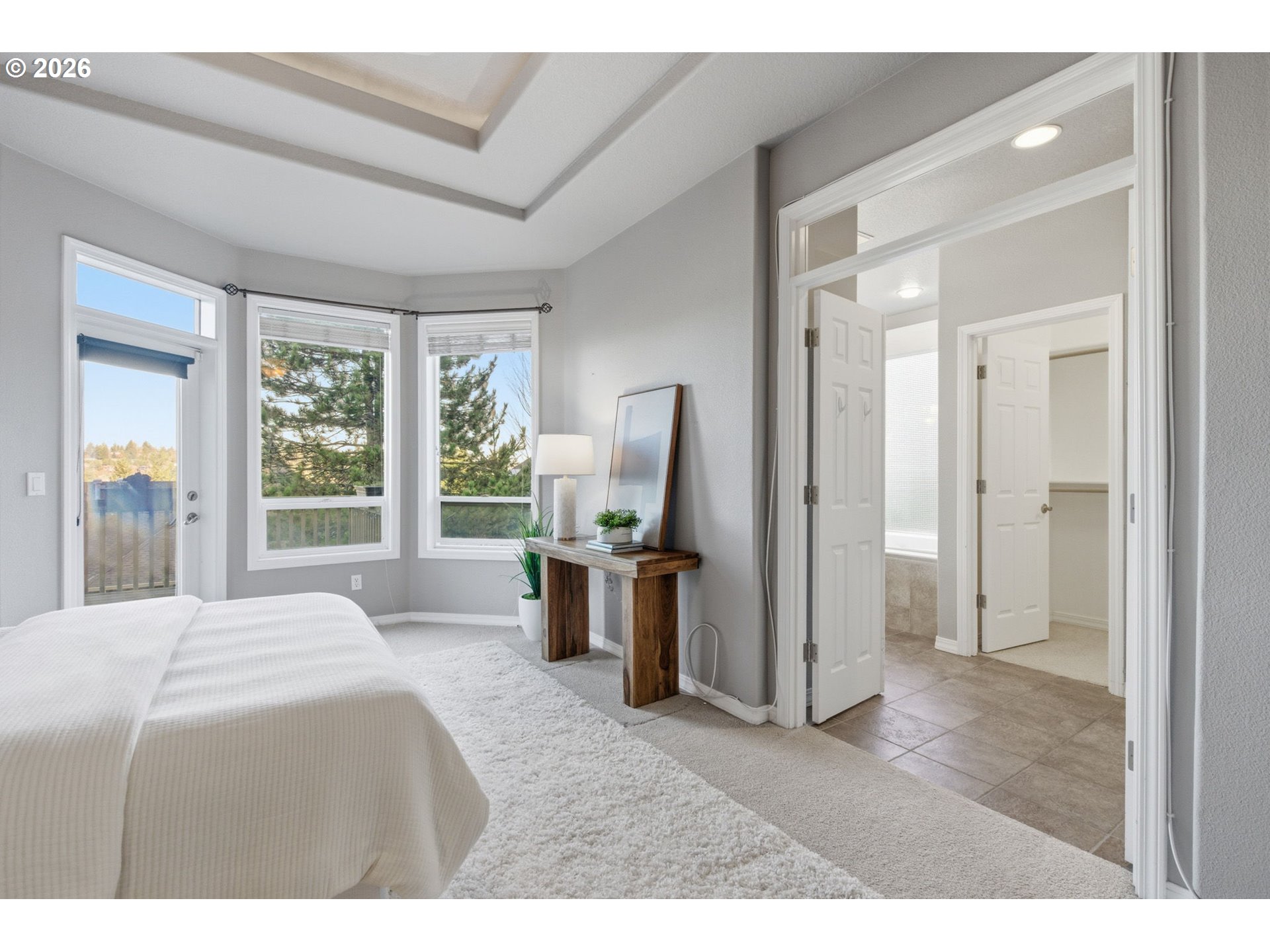 11086 Southeast Rimrock Drive Happy Valley, OR 97086 - Photo 19 of 39 a bedroom with a bed flat screen tv and a large window