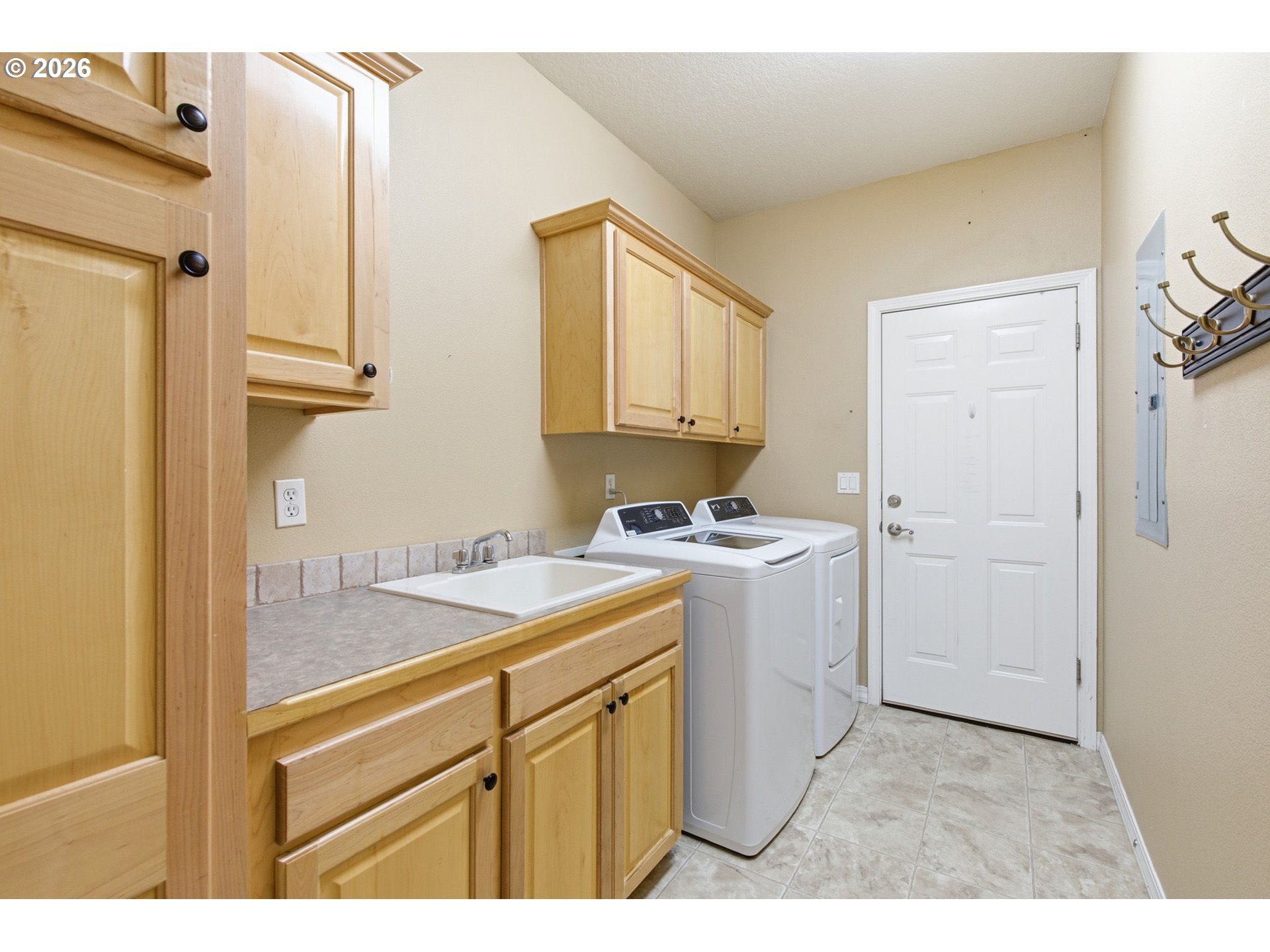 11086 Southeast Rimrock Drive Happy Valley, OR 97086 - Photo 29 of 39 a utility room with cabinets washer and dryer