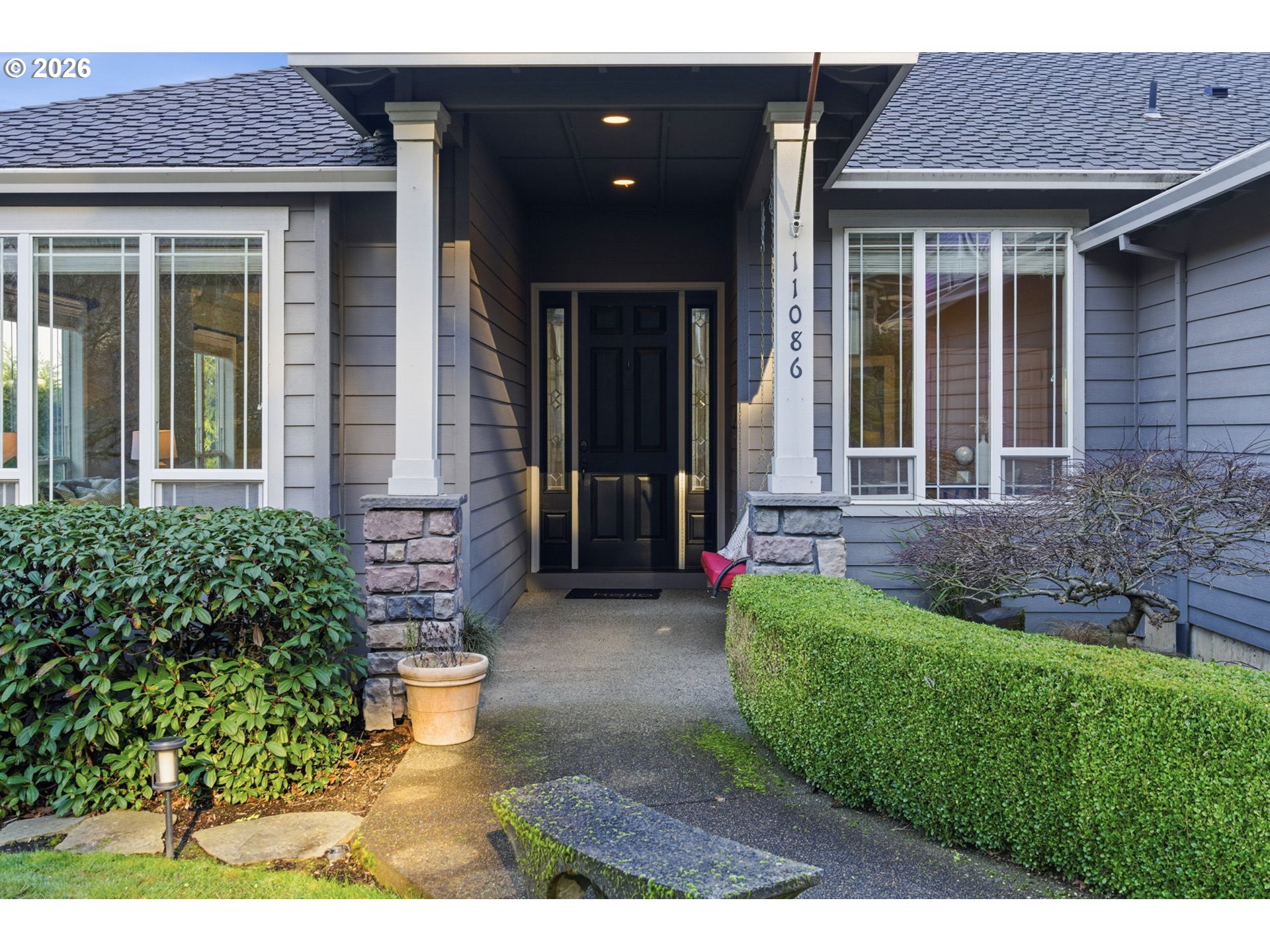 11086 Southeast Rimrock Drive Happy Valley, OR 97086 - Photo 3 of 39 a front view of a house with a yard
