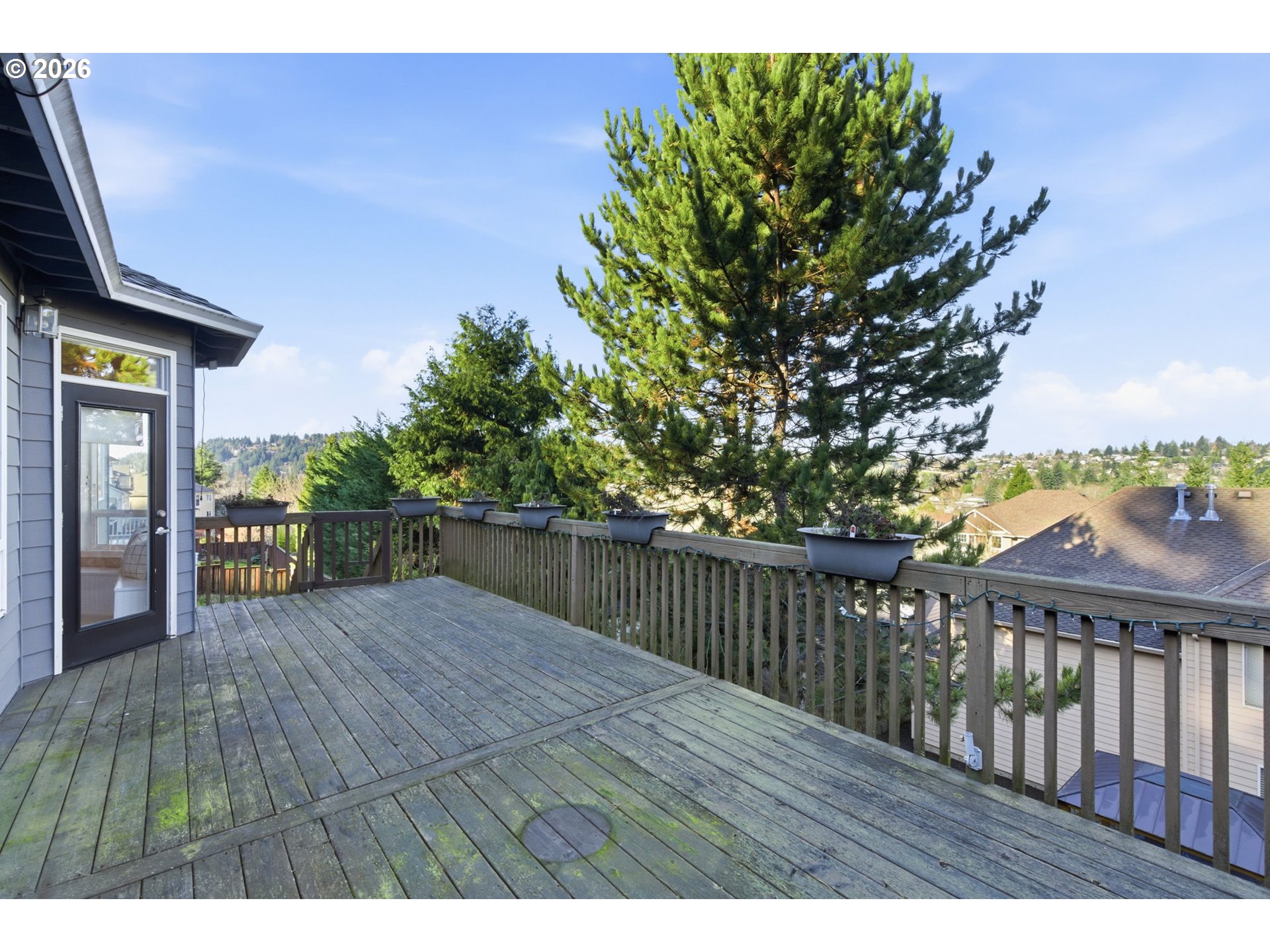 11086 Southeast Rimrock Drive Happy Valley, OR 97086 - Photo 31 of 39 a balcony with wooden floor and yard in the back