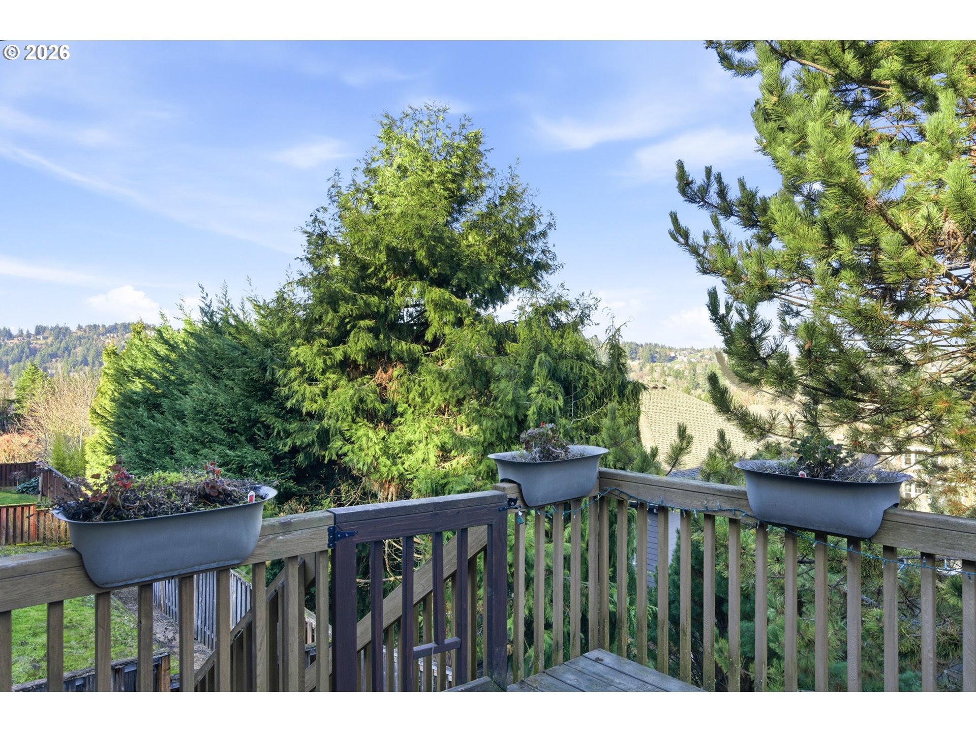 11086 Southeast Rimrock Drive Happy Valley, OR 97086 - Photo 34 of 39 a balcony with wooden floor and trees in the background