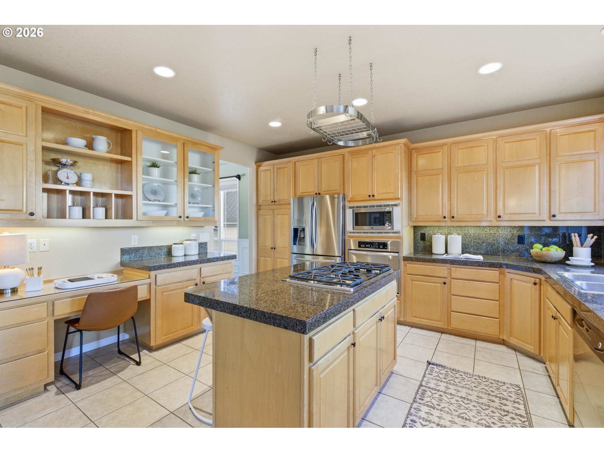 11086 Southeast Rimrock Drive Happy Valley, OR 97086 - Photo 10 of 39 a kitchen with stainless steel appliances granite countertop a sink and cabinets