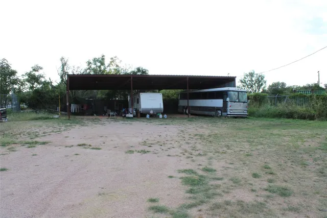 a backyard of a house with fire pit and chairs
