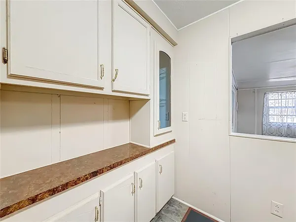 a view of a kitchen cabinets and window