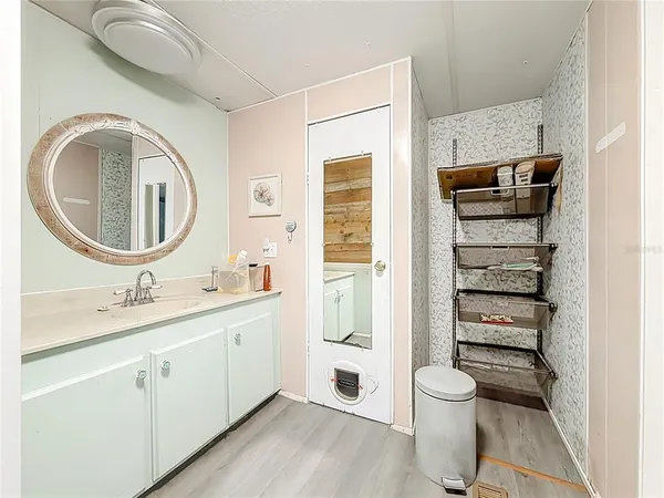 a bathroom with a toilet a sink and a mirror