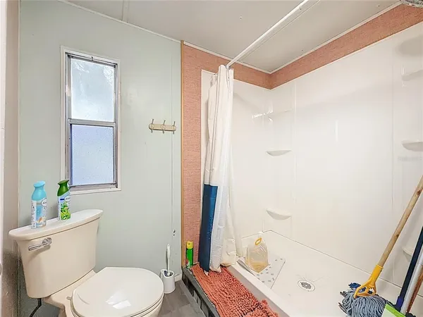 a white toilet sitting next to a bathroom sink