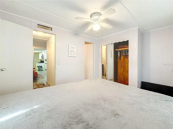 a view of a big room with closet and a bathroom