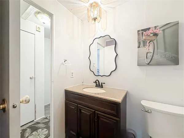 a bathroom with a sink vanity and a mirror