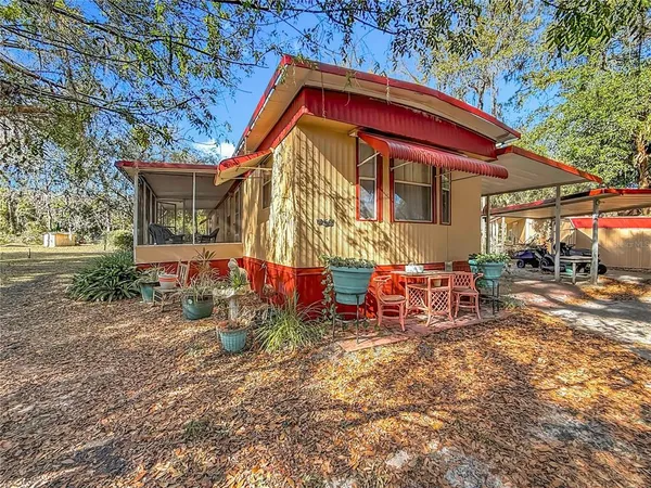 a view of house with a yard