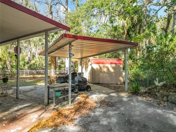 a view of a patio with table and chairs under an umbrella