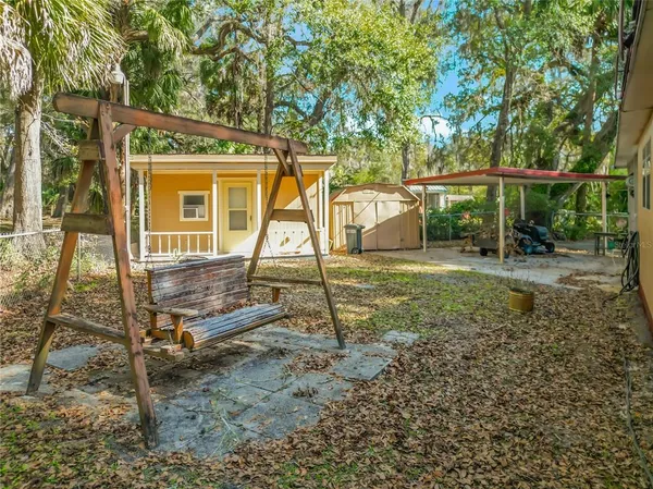 a backyard of a house with table and chairs