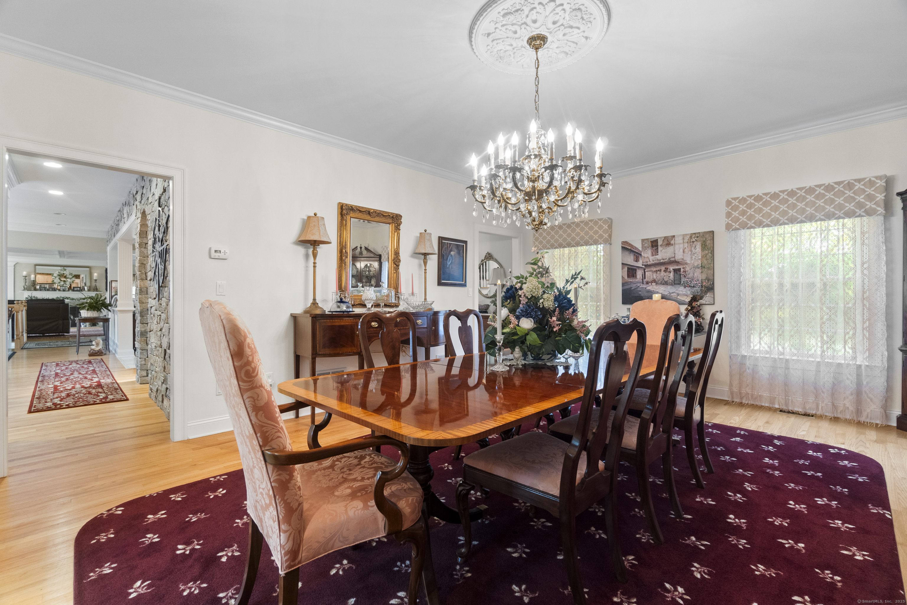 38 Sportsman Hill Road Madison, CT 06443 - Photo 14 of 40 a dining room with furniture a chandelier and wooden floor