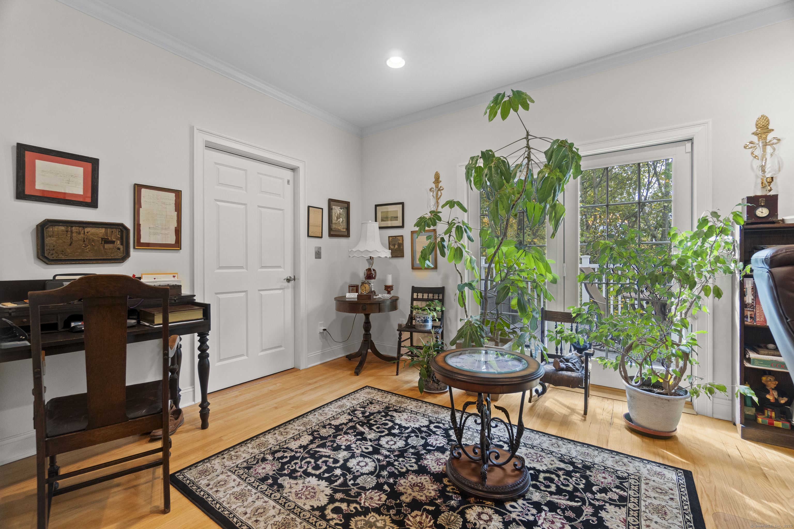 38 Sportsman Hill Road Madison, CT 06443 - Photo 15 of 40 a living room with patio furniture and a potted plant