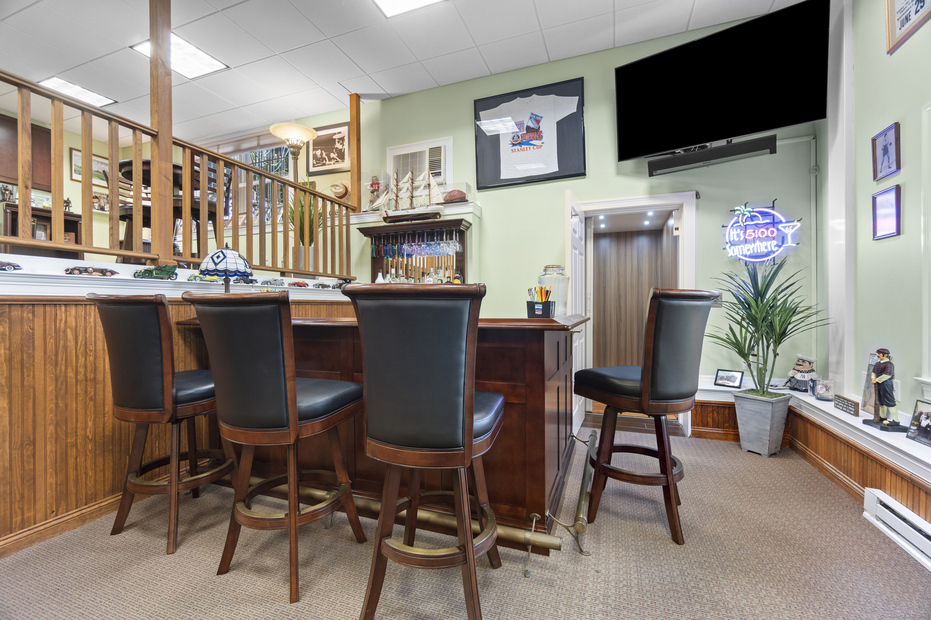 38 Sportsman Hill Road Madison, CT 06443 - Photo 31 of 40 a view of a dining room with furniture and a flat screen tv
