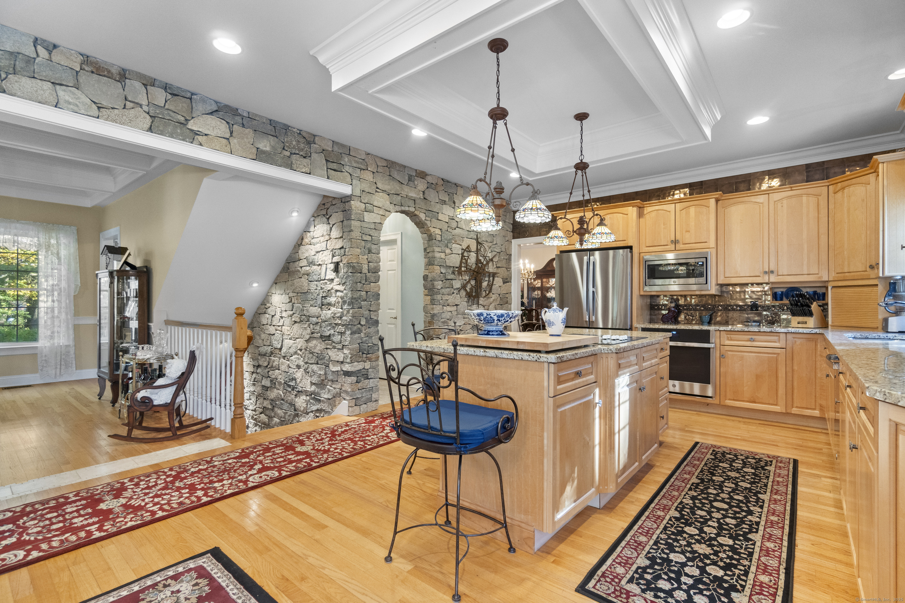 38 Sportsman Hill Road Madison, CT 06443 - Photo 4 of 40 a kitchen with stainless steel appliances granite countertop a stove a sink dishwasher a dining table and chairs with wooden floor