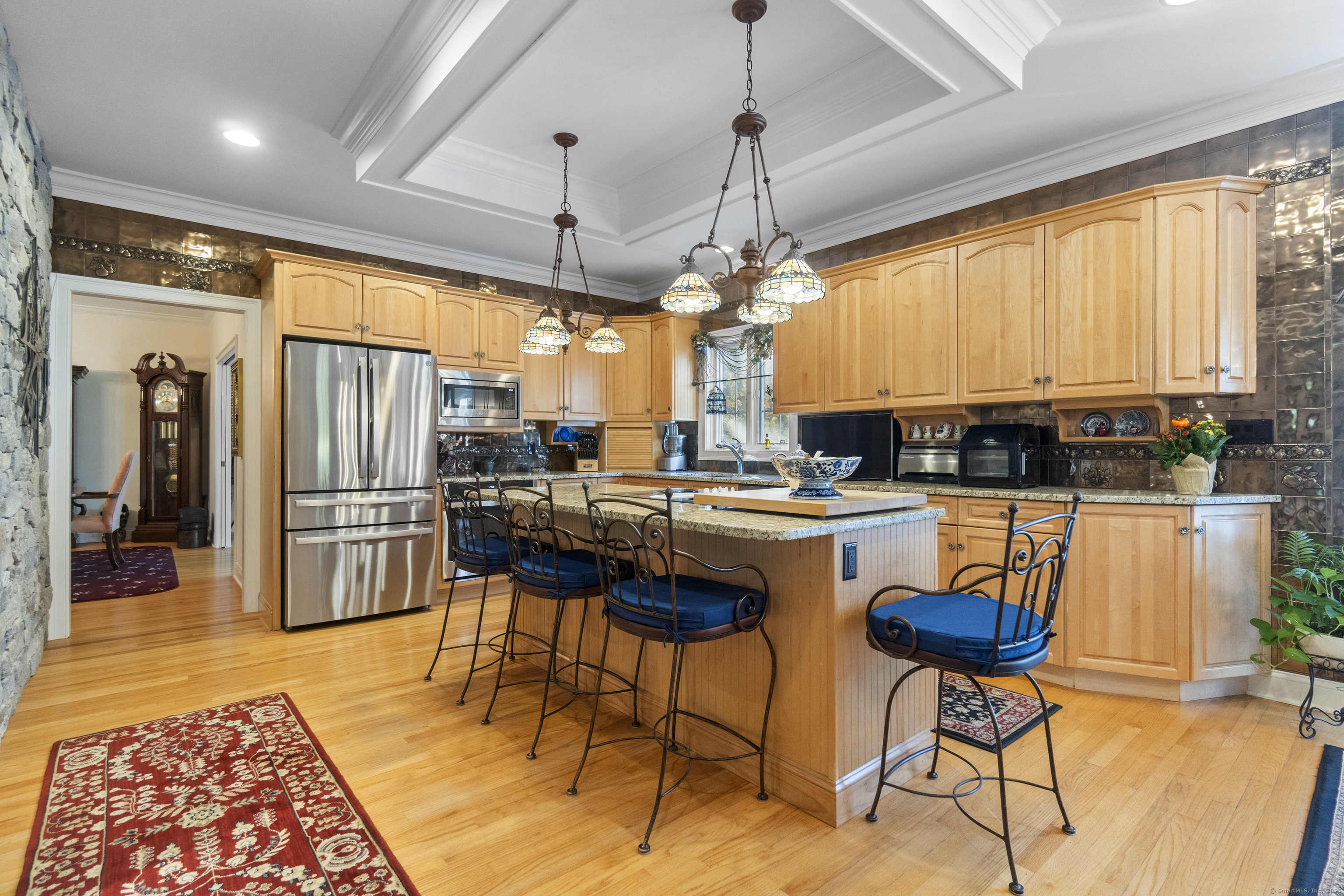 38 Sportsman Hill Road Madison, CT 06443 - Photo 6 of 40 a kitchen with stainless steel appliances granite countertop a refrigerator a stove a sink a dining table and chairs with wooden floor