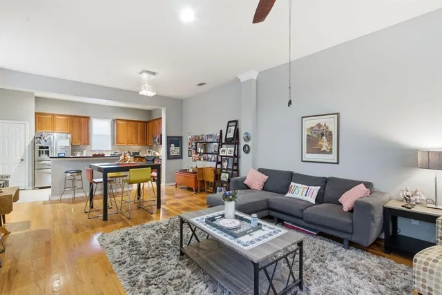 a living room with furniture kitchen view and a table