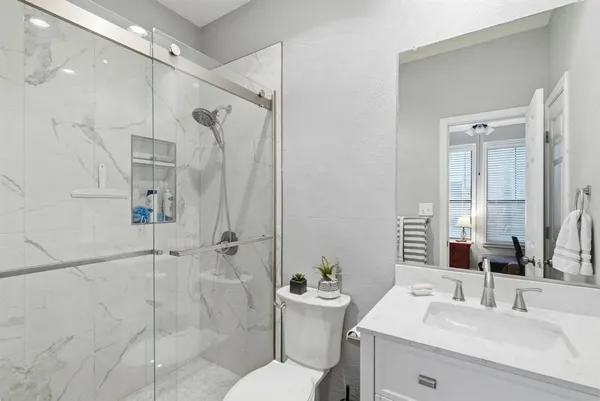 a bathroom with double vanity sinks and a mirror