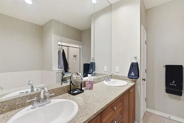 a bathroom with a bathtub sink and mirror