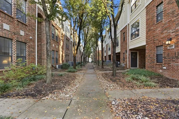 a view of a brick building next to a road