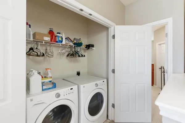 front view of a brick house with a small yard