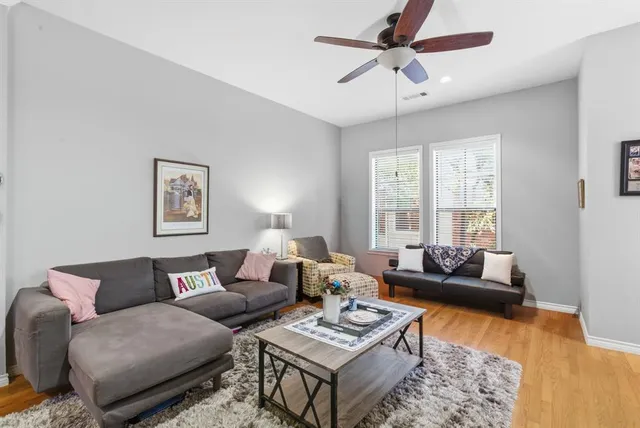 a living room with furniture a rug and a window