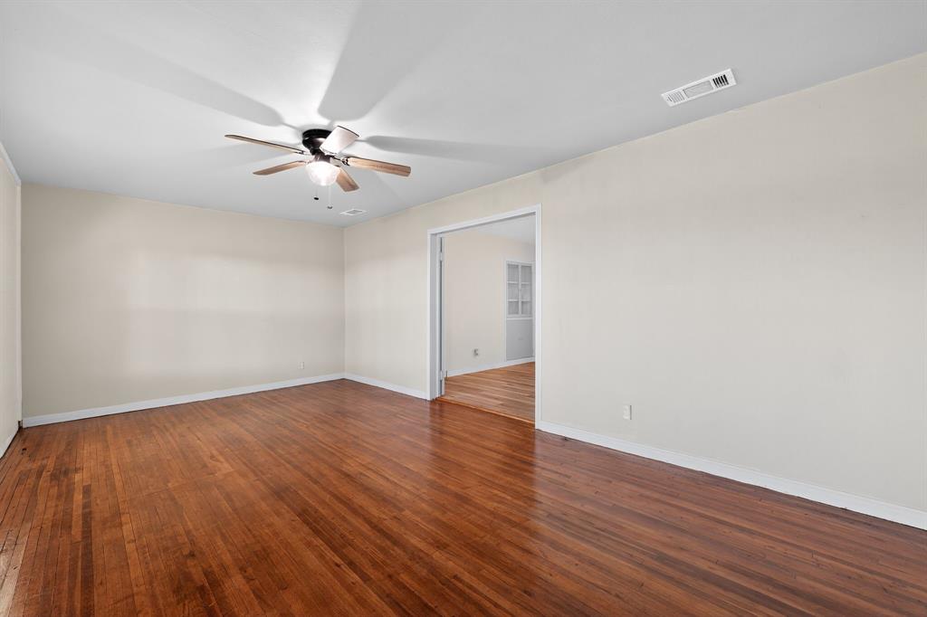 5485 Highway 7 Marlin, TX 76661 - Photo 25 of 36 Empty room with dark wood-style floors and a ceiling fan