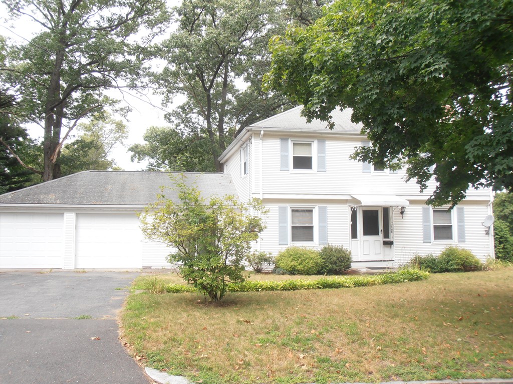 a front view of a house with a yard garage and outdoor seating