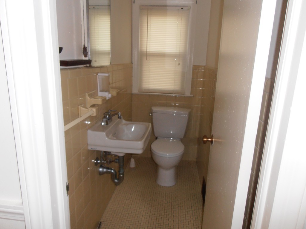 168 Emerson Street Springfield, MA 01118 - Photo 12 of 14 a bathroom with a sink a toilet and a mirror