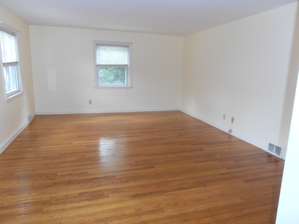 168 Emerson Street Springfield, MA 01118 - Photo 4 of 14 an empty room with wooden floor and windows