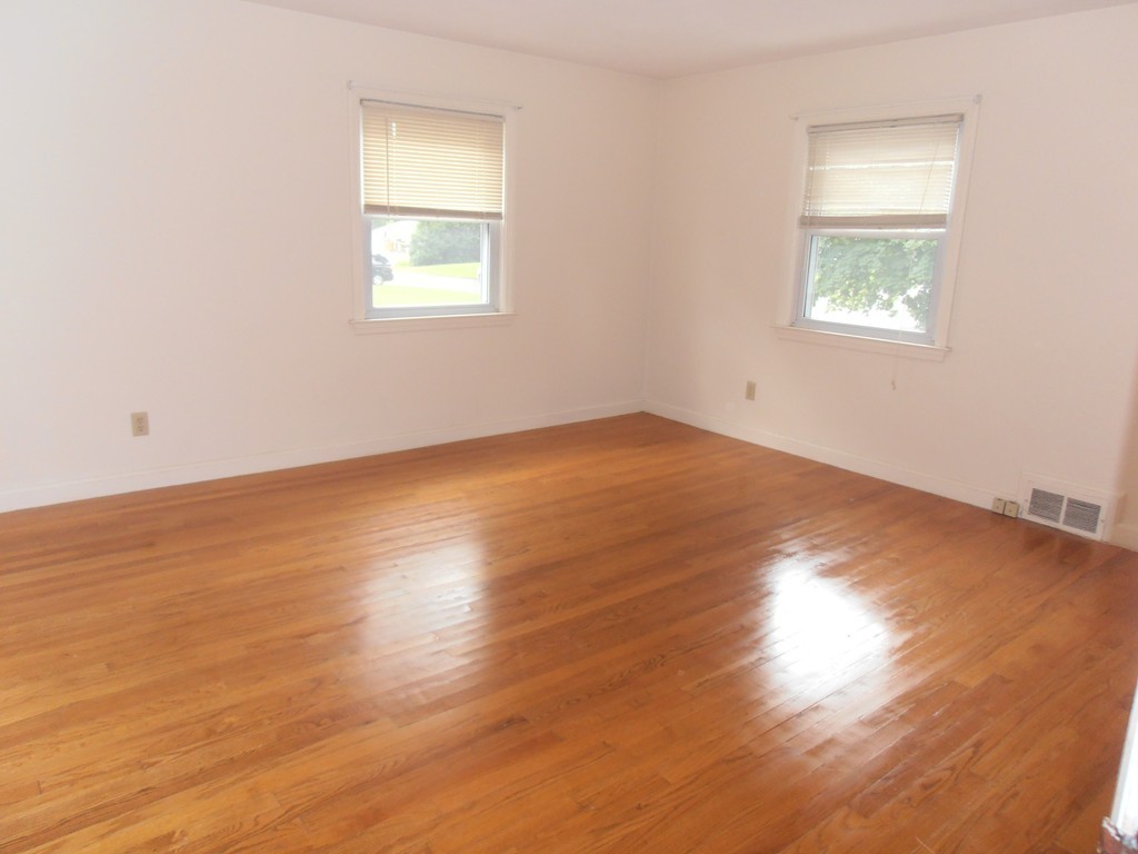 168 Emerson Street Springfield, MA 01118 - Photo 8 of 14 an empty room with wooden floor and windows