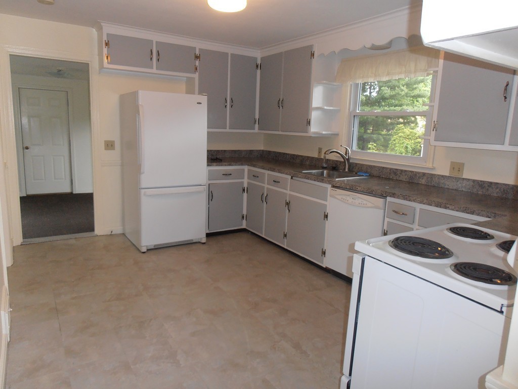 168 Emerson Street Springfield, MA 01118 - Photo 9 of 14 a kitchen with a refrigerator sink and cabinets