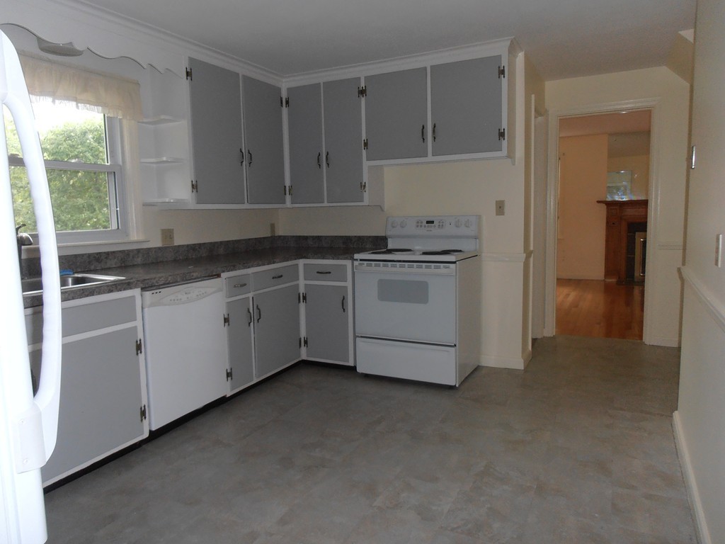 168 Emerson Street Springfield, MA 01118 - Photo 10 of 14 a kitchen with granite countertop white cabinets and white appliances