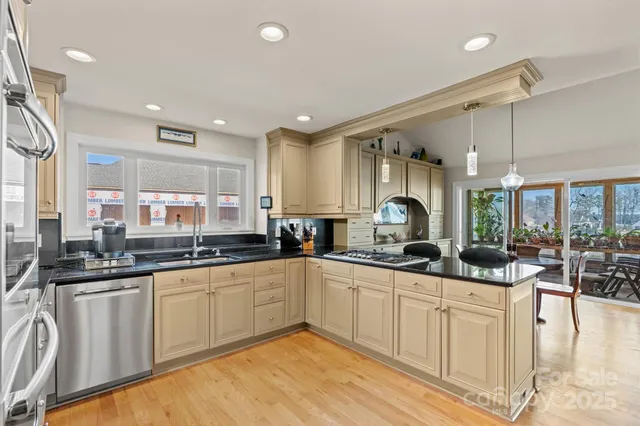 a kitchen with granite countertop a sink and cabinets