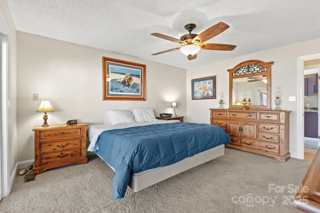 a bedroom with a bed and a ceiling fan