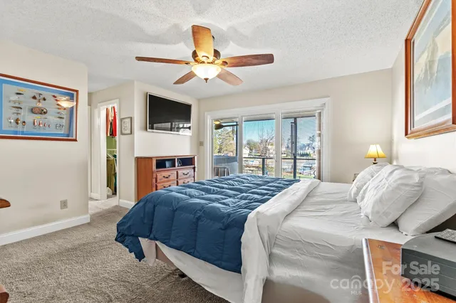 a bathroom with a granite countertop sink a toilet a shower and a mirror