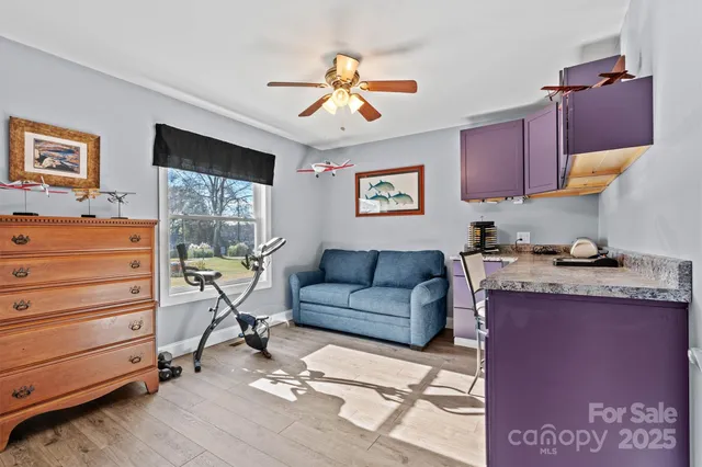 a view of a livingroom with furniture and a window
