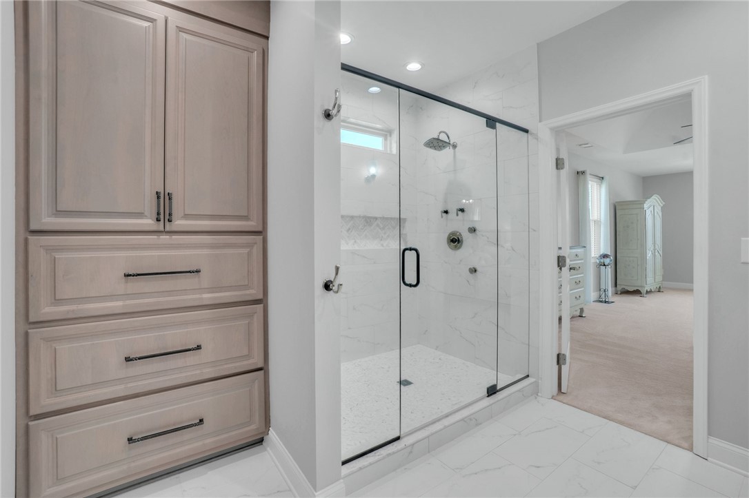 116 Stone Cottage Drive Anderson, SC 29621 - Photo 24 of 43 Custom cabinetry and a glass-enclosed walk-in shower highlight this modern primary bath design.