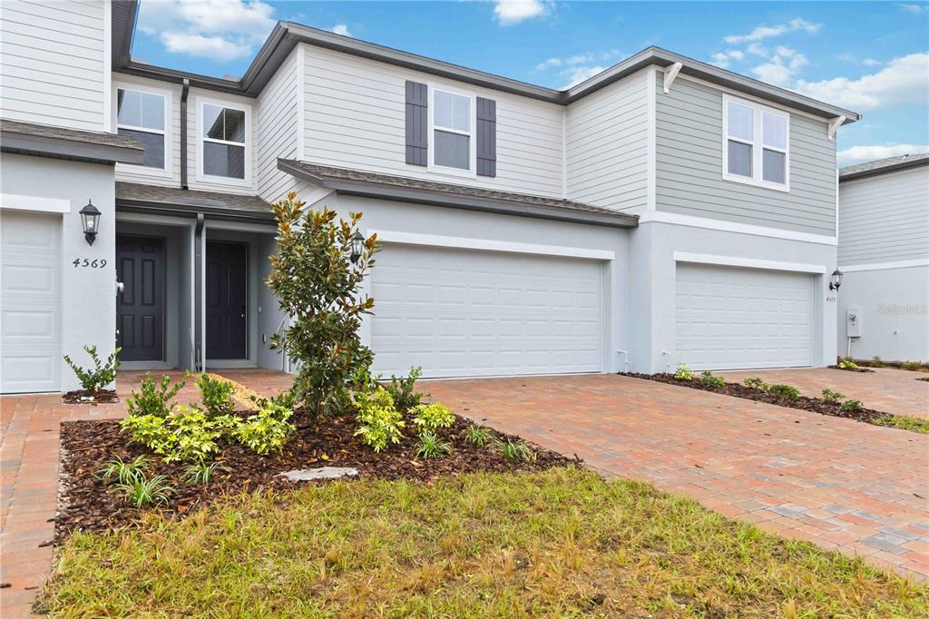 4571 Range Land Way St. Cloud, FL 34772 - Photo 1 of 43 a front view of a house with a yard and garage
