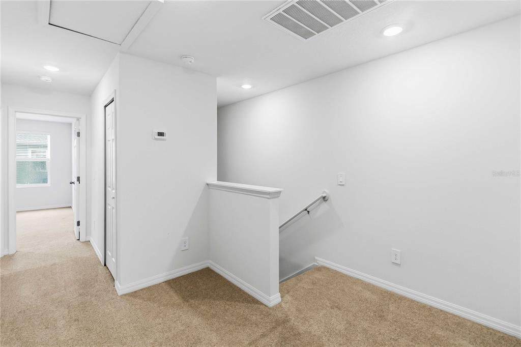 4571 Range Land Way St. Cloud, FL 34772 - Photo 14 of 43 an empty room with a hallway